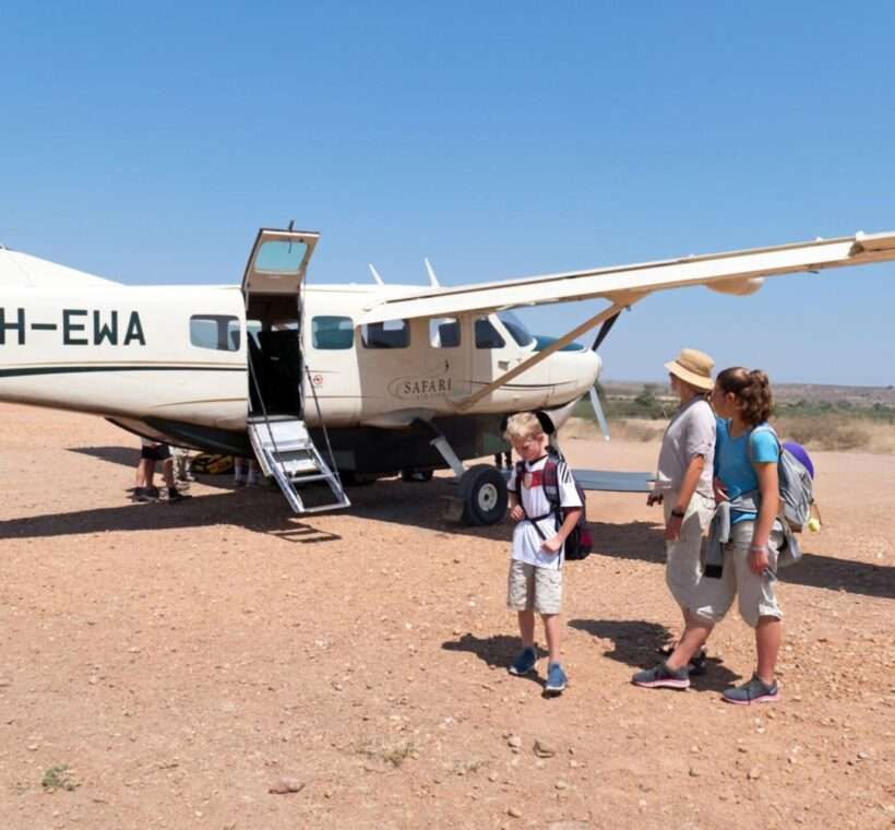 What to pack on a Kenyan Safari: Tips and Tricks 1 A family with children is waiting near a Cessna 208 B Grand Caravan after arrival at the airstrip