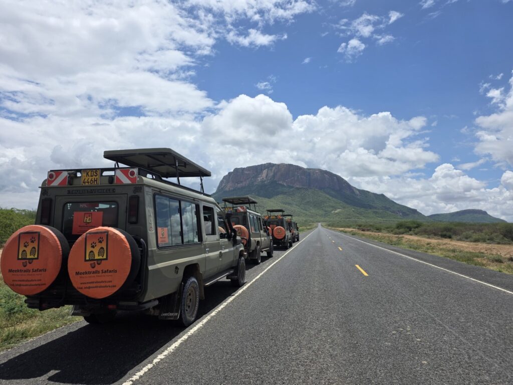 Mt. Ololokwe: The Sacred Mountain of Northern Kenya 4 safari vehicles near ololokwe